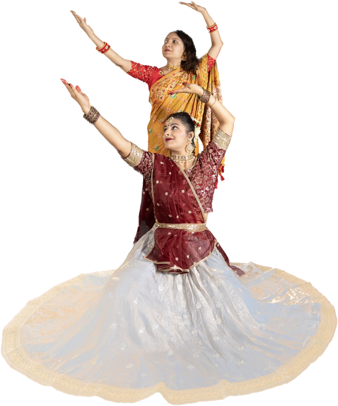 Smt. Hiral Joshi and her student Jia in a Kathak pose, arms raised in unison